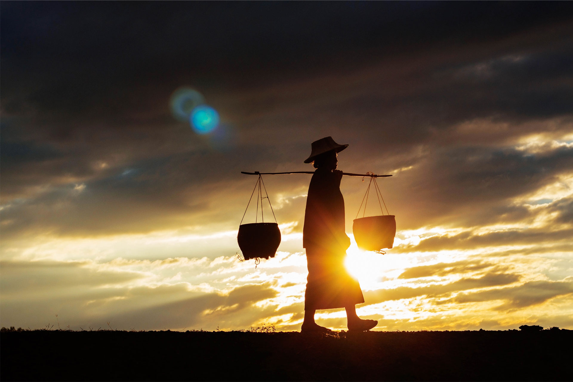 Farmer Walking on the Hill for Water
